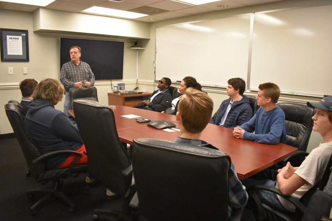 Students sitting around conference room table